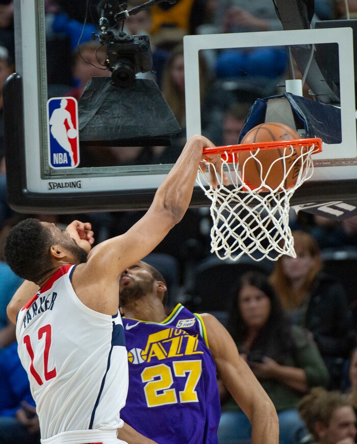 (Rick Egan  |  The Salt Lake Tribune)        Washington Wizards forward Jabari Parker (12) goes in for a slam dunk, as Utah Jazz center Rudy Gobert (27) defends, in NBA action between the Utah Jazz and the Washington Wizards, in Salt Lake City, Friday, March 29, 2019.