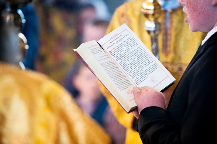 (Isaac Hale | Special to The Tribune) Benjamin Havens, 12, reads during a consecration service for St. Xenia Orthodox Church in Payson on Saturday, July 16, 2022.