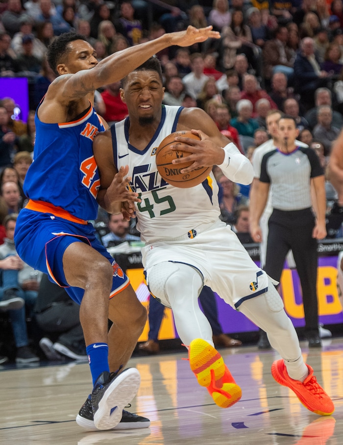 (Rick Egan  |  The Salt Lake Tribune)  Utah Jazz guard Donovan Mitchell (45) drives inside with the ball, as New York Knicks forward Lance Thomas (42) defends, in NBA action between Utah Jazz and New York Knicks, in Salt Lake City, Saturday, Dec. 29, 2018.