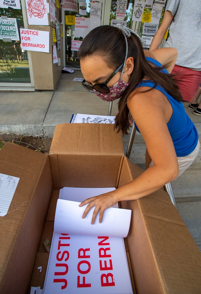 (Rick Egan  |  The Salt Lake Tribune)      Protesters grab signs to put on the Salt Lake District Attorney's office, during a Justice for Bernardo demonstration, in Salt Lake City, Tuesday, July 7, 2020.