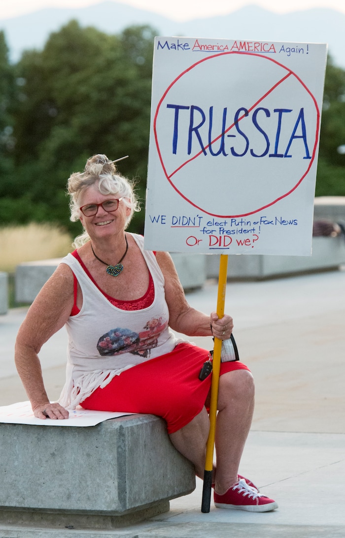 (Rick Egan  |  The Salt Lake Tribune)     Barbara Barnett, of Salt Lake City, holds a sign at the Confront Corruption:Demand Democracy vigil on the steps of the Utah State Capitol, Wednesday. Salt Lake City joined more than 110 vigils nationwide to stand against corruption in the United States, July 18, 2018.
