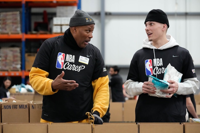 (Francisco Kjolseth | The Salt Lake Tribune) Thomas Vines, left, speaks with basketball player Tyler Herro of the Miami Heat as they join hundreds of volunteers for a hands-on service projects focused on alleviating food insecurity during the NBA Cares Day of Service in Salt Lake City on Feb. 17, 2023.