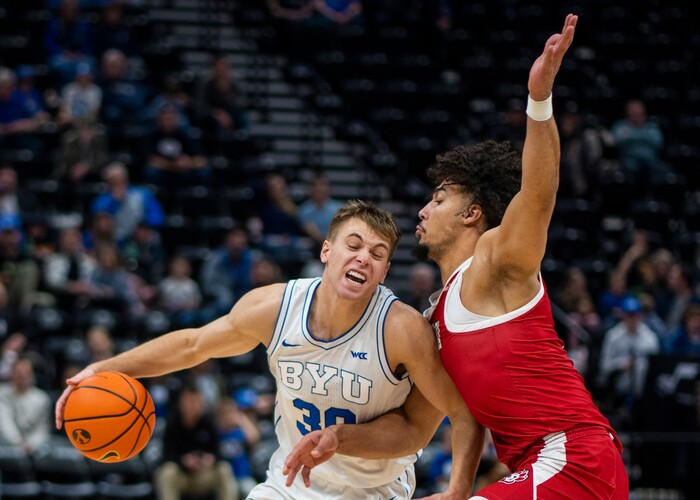 (Rick Egan | The Salt Lake Tribune)  Brigham Young Cougars guard Dallin Hall (30) tries to get past South Dakota Coyotes guard Damani Hayes (2), in basketball action between the Brigham Young Cougars and the South Dakota Coyotes, at Vivint Arena, in Salt Lake City, on Saturday, Dec. 3, 2022.