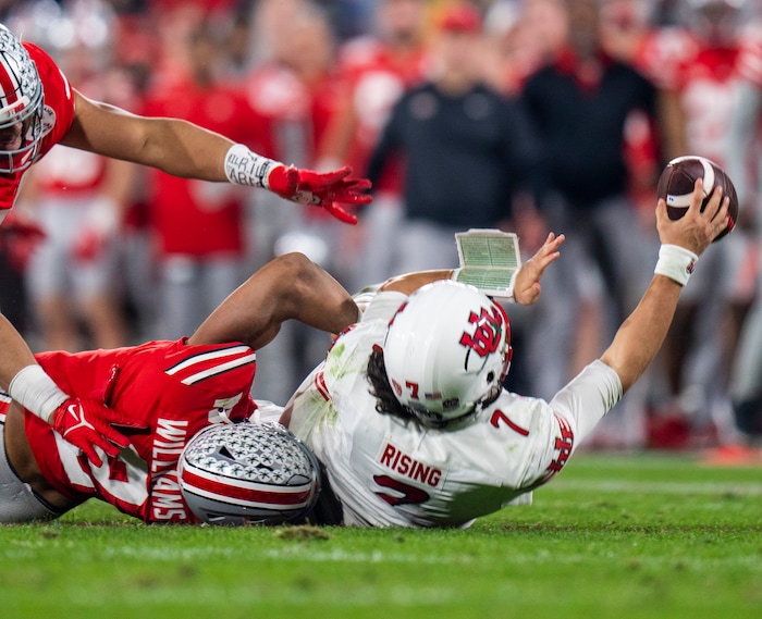 (Rick Egan | The Salt Lake Tribune) Utah quarterback Cameron Rising (7) is brought down Ohio State Buckeyes safety Kourt Williams II as he tries to get rid of the ball. Rising was shaken up on the play as was taken out of the game after the play, in Rose Bowl action between the  Utah Utes and the Ohio State Buckeyes Pasadena, on Saturday, January 1, 2022.