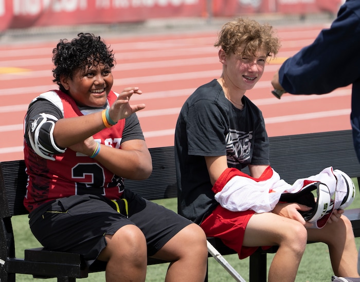 (Rick Egan | The Salt Lake Tribune)  Edward Tonga and Will Pearson joke with teammates, during  East youth lacrosse practice, on Wednesday, June 22, 2022.