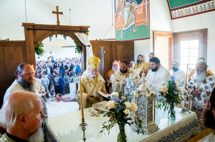 (Isaac Hale | Special to The Tribune) Metropolitan Joseph, leader of the Antiochian Orthodox Christian Archdiocese of North America, sprinkles the second covering and items on the holy table with holy water as he and clergy participate in the vesting of the holy table during a consecration service for St. Xenia Orthodox Church in Payson on Saturday, July 16, 2022.