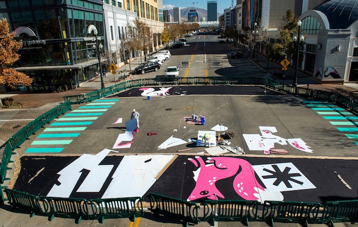 (Rick Egan | The Salt Lake Tribune). Workers paint the crosswalk at the intersection of 100 South and Rio Grande Street, on Wednesday, Nov. 4, 2020.
