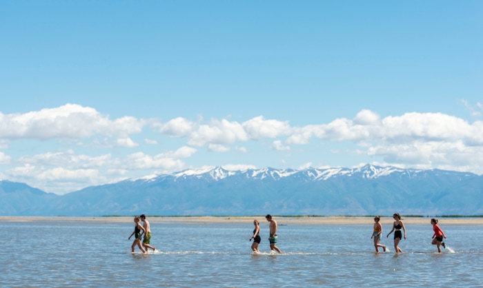 (Rick Egan  |  The Salt Lake Tribune)       Participants brave the cold temperature as they venture out into the water at the Great Salt Lake Saturday, June 8, 2019.  The cool temperatures resulted in crowd of around 300 people, so the attempt to break the world record was turned into a polar plunge.