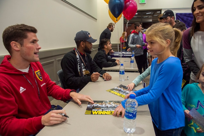 (Rick Egan  |  The Salt Lake Tribune)    Kaylee Carlson, 9, gets an autograph form Sam Brown, as the Real Monarchs celebrate their USL Cup Championship, during their championship parade at Lynn Crane Park in Herriman, Wednesday, Nov. 20, 2019.