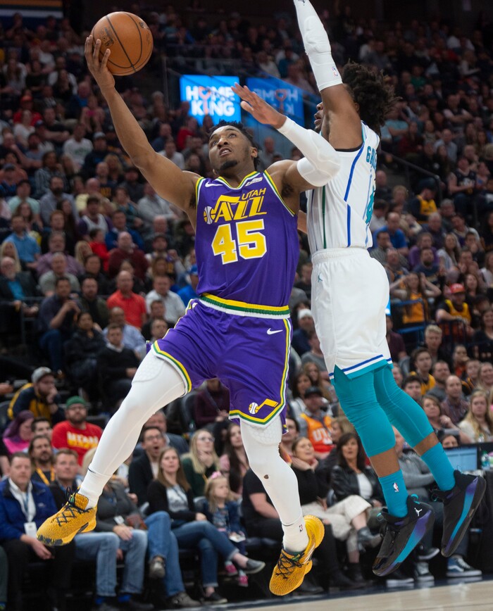 (Rick Egan  |  The Salt Lake Tribune)   Utah Jazz guard Donovan Mitchell (45) takes the ball to the hoop, as Charlotte Hornets guard Devonte' Graham (4) defends, in NBA action between the Utah Jazz and the Charlotte Hornets, in Salt Lake City,  Monday, April 1, 2019.