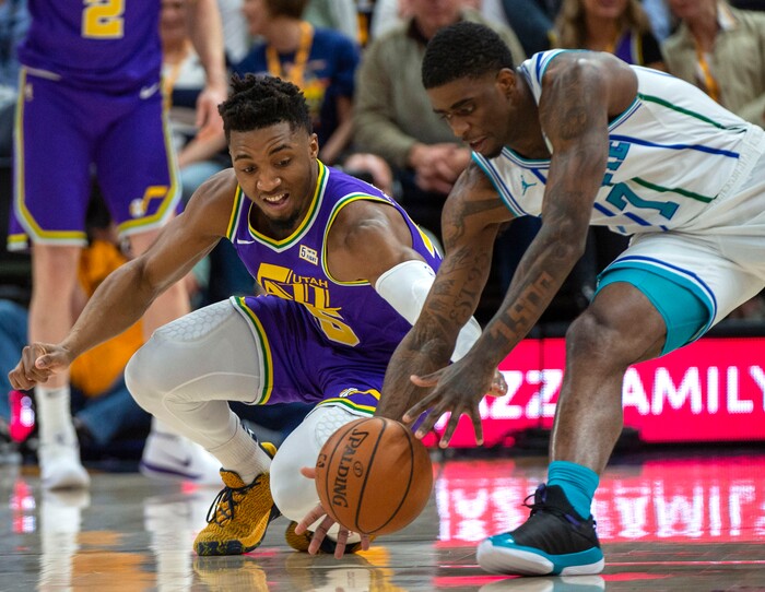 (Rick Egan  |  The Salt Lake Tribune)   Utah Jazz guard Donovan Mitchell (45) goes for a loose ball along with Charlotte Hornets guard Dwayne Bacon (7), in NBA action between the Utah Jazz and the Charlotte Hornets, in Salt Lake City,  Monday, April 1, 2019.
