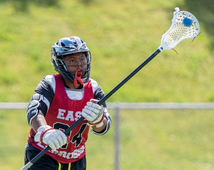 (Rick Egan | The Salt Lake Tribune)  Edward Tonga runs drills, during East youth lacrosse practice, on Wednesday, June 22, 2022.