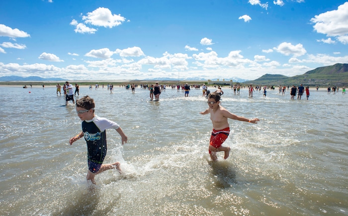 (Rick Egan  |  The Salt Lake Tribune)       Brave kids ignore the cold temperature as they splash through the water at the Great Salt Lake Saturday, June 8, 2019.  The cool temperatures resulted in a crowd of around 300 people, so the attempt to break the world record was turned into a polar plunge.