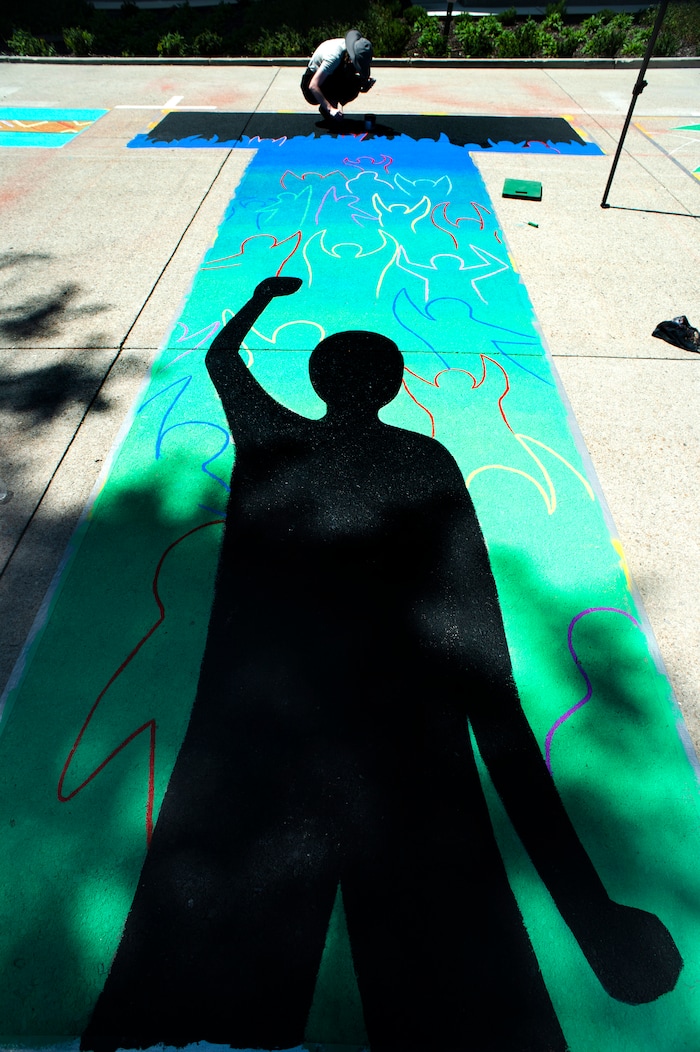 (Rick Egan  |  The Salt Lake Tribune)     Veronica Zac paints the letter ÒTÓ in the Black Lives Matter mural, on the south side of City Hall on Tuesday, Aug. 4, 2020.
