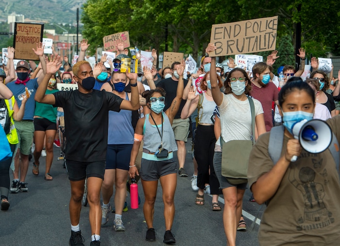 (Rick Egan  |  The Salt Lake Tribune)     Protesters shout "hands up don't shoot" as they march down the street in Salt Lake City, during a Justice for Bernardo rally on Thursday, June 25, 2020.