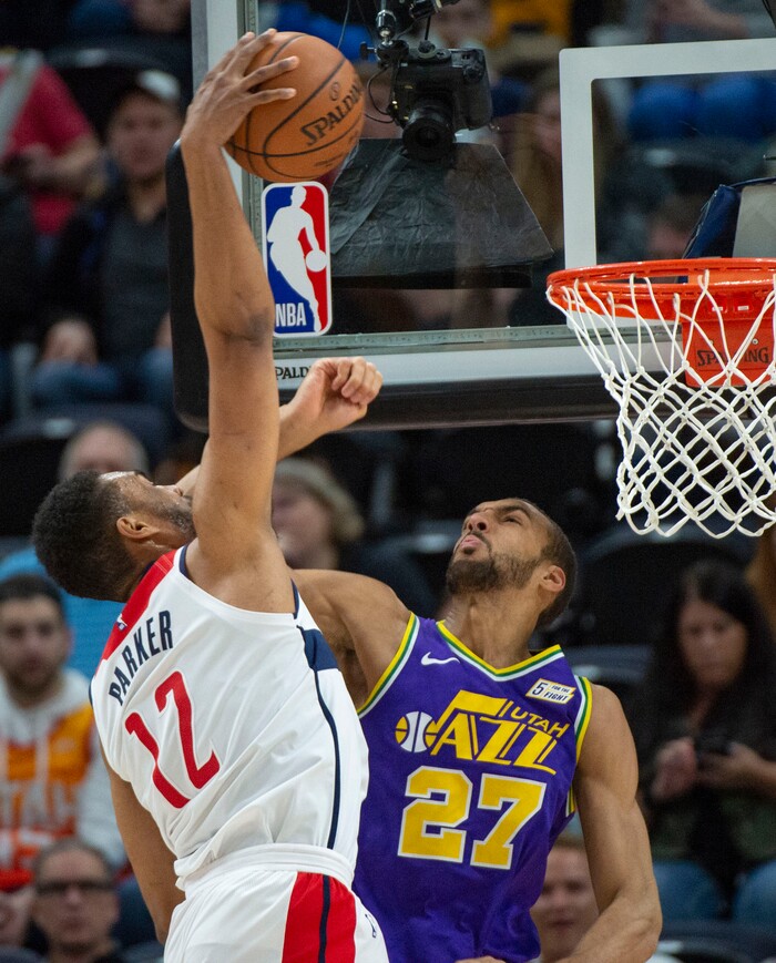 (Rick Egan  |  The Salt Lake Tribune)        Washington Wizards forward Jabari Parker (12) goes in for a slam dunk, as Utah Jazz center Rudy Gobert (27) defends, in NBA action between the Utah Jazz and the Washington Wizards, in Salt Lake City, Friday, March 29, 2019.