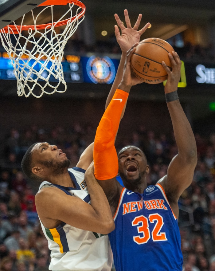 (Rick Egan  |  The Salt Lake Tribune) New York Knicks forward Noah Vonleh (32) shoots as Utah center Ekpe Udoh (33) defends for the Jazz, in NBA action between Utah Jazz and New York Knicks, in Salt Lake City, Saturday, Dec. 29, 2018.