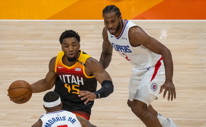 (Rick Egan | The Salt Lake Tribune) Donovan Mitchell (45) splits the LA defenders, forward Kawhi Leonard (2)] and Clippers forward Marcus Morris Sr. (8) to score for the Jazz, in NBA action between the Utah Jazz and the LA Clippers, in game one in the second round of the NBA playoff series at Vivint Arena, on Tuesday, June 8, 2021.
