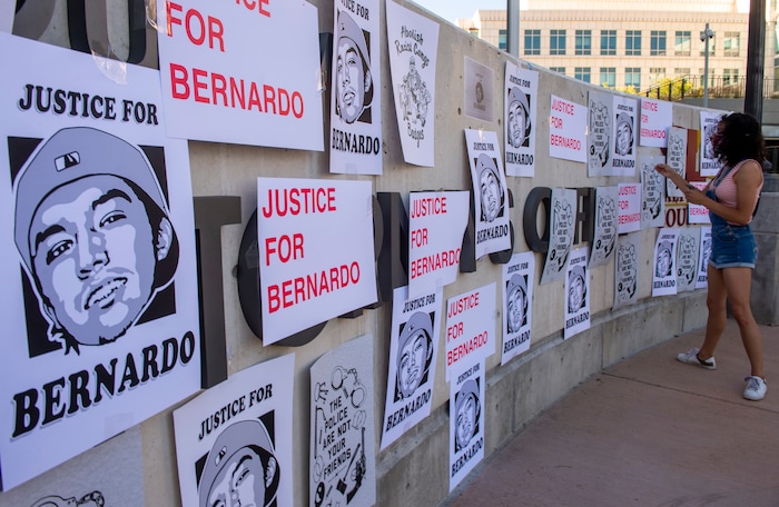 (Rick Egan  |  The Salt Lake Tribune)     Protesters tape signs on the Salt Lake City District Attorney's office, during a Justice for Bernardo Palacios protest on Tuesday, June 23, 2020.