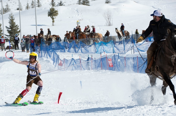 (Rick Egan  |  The Salt Lake Tribune)   Caden Spencer is pulled by Jake Ream, riding Cadillac the horse, for the team "Snow Choppers", in the first day of the Skijoring competition at Soldier Hollow Friday.  Feb. 22, 2019.  The competition continues on Saturday.