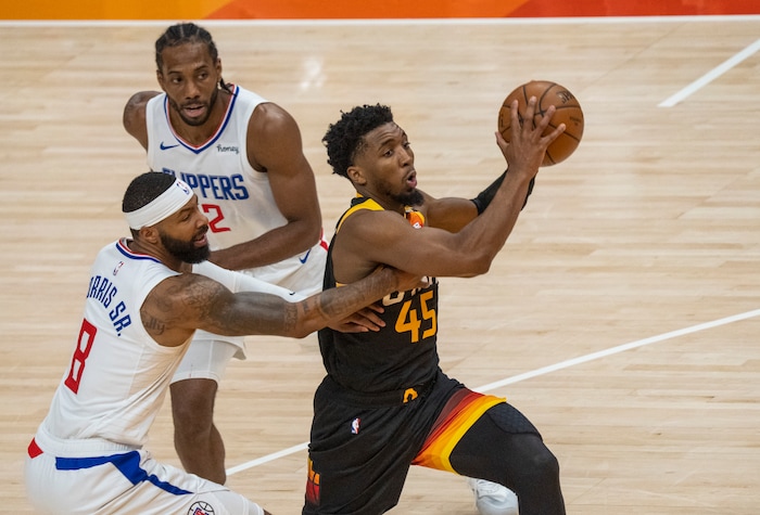(Rick Egan | The Salt Lake Tribune) Donovan Mitchell (45) splits the LA defenders, forward Kawhi Leonard (2)] and Clippers forward Marcus Morris Sr. (8) to score for the Jazz, in NBA action between the Utah Jazz and the LA Clippers, in game one in the second round of the NBA playoff series at Vivint Arena, on Tuesday, June 8, 2021.