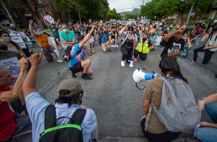 (Rick Egan  |  The Salt Lake Tribune)     Protesters stop and take a knee in remembrance of Bernardo in a Salt Lake City intersection, during a Justice for Bernardo rally on Thursday, June 25, 2020.