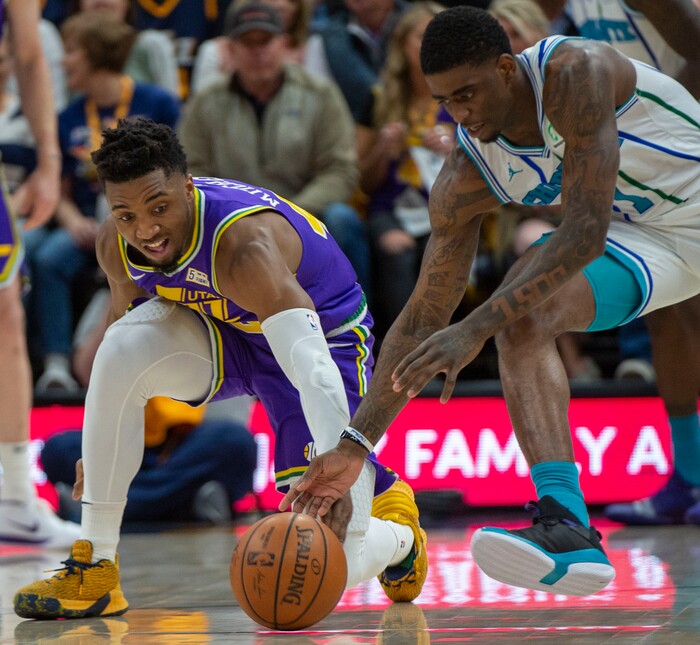 (Rick Egan  |  The Salt Lake Tribune)   Utah Jazz guard Donovan Mitchell (45) goes for a loose ball along with Charlotte Hornets guard Dwayne Bacon (7), in NBA action between the Utah Jazz and the Charlotte Hornets, in Salt Lake City,  Monday, April 1, 2019.