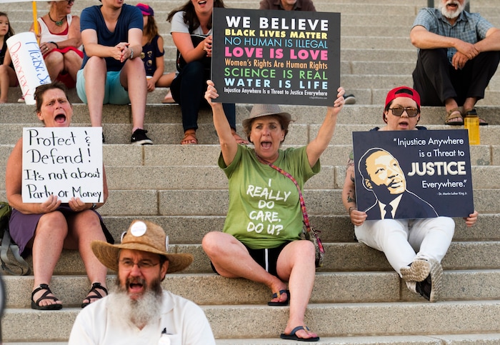 (Rick Egan  |  The Salt Lake Tribune)     protestors, chant at the Confront Corruption:Demand Democracy vigil  on the steps of the Utah State Capitol, Wednesday. Salt Lake City joined more than 110 vigils nationwide to stand against corruption in the United States, July 18, 2018.