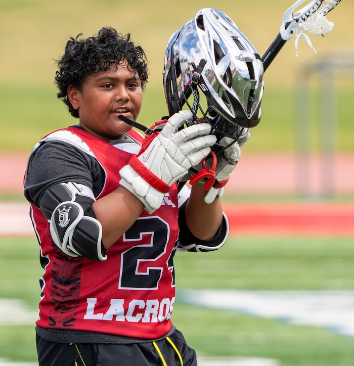 (Rick Egan | The Salt Lake Tribune)  Edward Tonga (24) walks back on the field after a water break, during East youth lacrosse practice, on Wednesday, June 22, 2022.