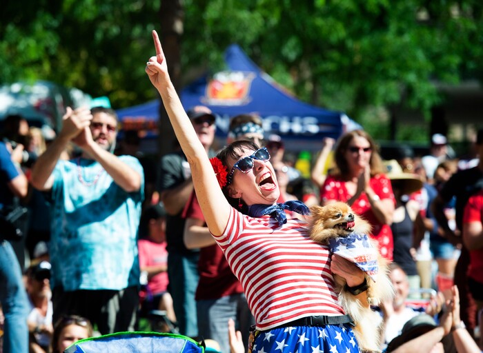 (Rick Egan  |  The Salt Lake Tribune)   Andie Whitworth Pace and her dog Zoe cheer as the US women's team scores a goal against the Netherlands in the World Cup final, during a watch party at the Gallivan Center in Salt Lake, Sunday, July 7, 2019.