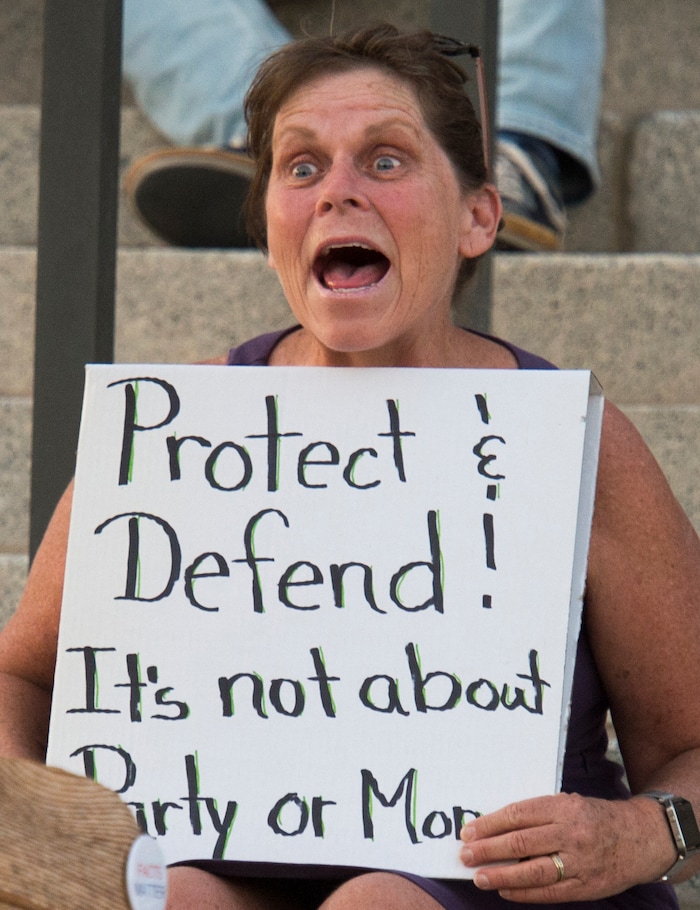 (Rick Egan  |  The Salt Lake Tribune)     Sara Willard from Sandy, joins in a chant at the Confront Corruption:Demand Democracy vigil on the steps of the Utah State Capitol, Wednesday. Salt Lake City joined more than 110 vigils nationwide to stand against corruption in the United States, July 18, 2018.
