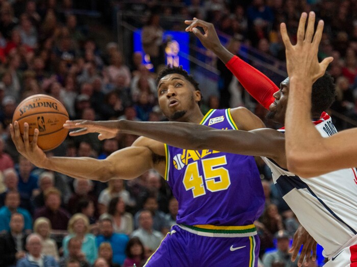 (Rick Egan  |  The Salt Lake Tribune)        Utah Jazz guard Donovan Mitchell (45) takes the ball to the hoop, as Washington Wizards forward Bobby Portis (5) defends, in NBA action between the Utah Jazz and the Washington Wizards, in Salt Lake City, Friday, March 29, 2019.