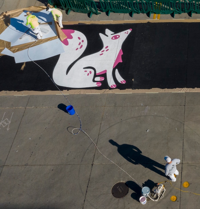 (Rick Egan | The Salt Lake Tribune). Workers paint the crosswalk at the intersection of 100 South and Rio Grande Street, on Wednesday, Nov. 4, 2020.