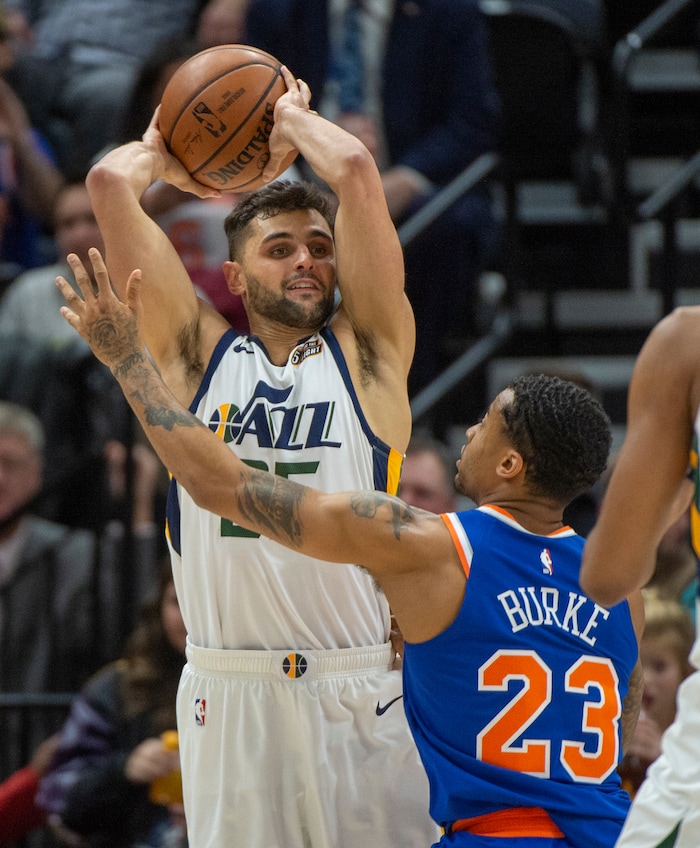 (Rick Egan  |  The Salt Lake Tribune) Utah Jazz guard Raul Neto (25) passes the ball over the top of New York Knicks guard Trey Burke (23), in NBA action between Utah Jazz and New York Knicks, in Salt Lake City, Saturday, Dec. 29, 2018.