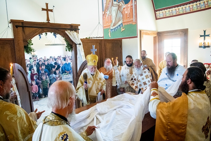 (Isaac Hale | Special to The Tribune) Metropolitan Joseph, leader of the Antiochian Orthodox Christian Archdiocese of North America, sprinkles the first covering with holy water as he and clergy participate in the vesting of the holy table during a consecration service for St. Xenia Orthodox Church in Payson on Saturday, July 16, 2022.