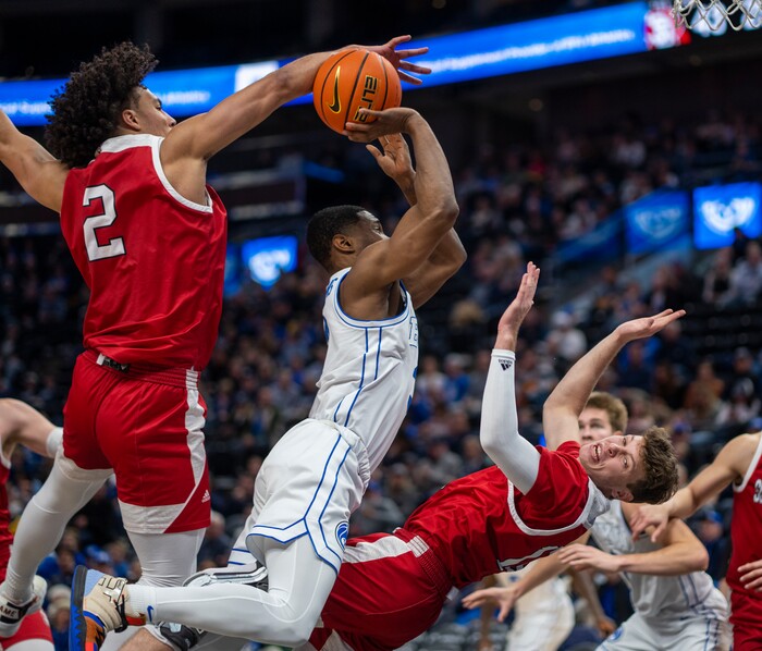 (Rick Egan | The Salt Lake Tribune)  Brigham Young Cougars guard Rudi Williams (3) is called for an offensive foul, as he collides with South Dakota Coyotes guard A.J. Plitzuweit (10) and South Dakota Coyotes guard A.J. Plitzuweit (10), in basketball action between the Brigham Young Cougars and the South Dakota Coyotes, at Vivint Arena, in Salt Lake City, on Saturday, Dec. 3, 2022.