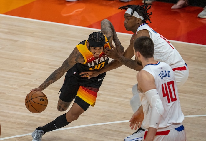 (Rick Egan | The Salt Lake Tribune) Utah Jazz guard Jordan Clarkson (00) takes the ball inside as LA Clippers guard Terance Mann (14) and LA Clippers center Ivica Zubac (40) defend, in NBA action between the Utah Jazz and the LA Clippers, in game one in the second round of the NBA playoff series at Vivint Arena, on Tuesday, June 8, 2021.