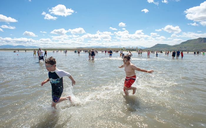 (Rick Egan  |  The Salt Lake Tribune)       Brave kids ignore the cold temperature as they splash through the water at the Great Salt Lake Saturday, June 8, 2019.  The cool temperatures resulted in a crowd of around 300 people, so the attempt to break the world record was turned into a polar plunge.