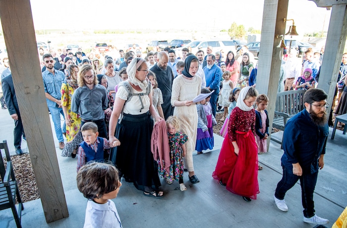 (Isaac Hale | Special to The Tribune) Members of the congregation make their way inside after processing around the church three times during a consecration service for St. Xenia Orthodox Church in Payson on Saturday, July 16, 2022.