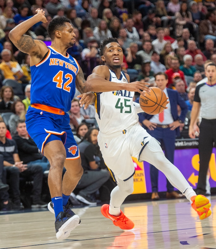 (Rick Egan  |  The Salt Lake Tribune)  Utah Jazz guard Donovan Mitchell (45) drives inside with the ball, as New York Knicks forward Lance Thomas (42) defends, in NBA action between Utah Jazz and New York Knicks, in Salt Lake City, Saturday, Dec. 29, 2018.