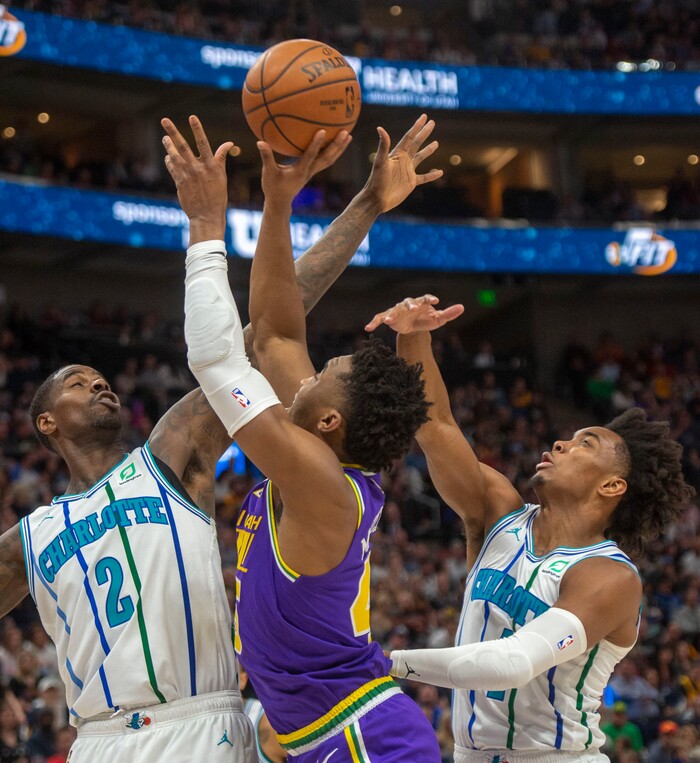 (Rick Egan  |  The Salt Lake Tribune)   Utah Jazz guard Donovan Mitchell (45) shoots as Charlotte forward Marvin Williams (2) and Charlotte guard Devonte' Graham (4) defend for the Hornets, in NBA action between the Utah Jazz and the Charlotte Hornets, in Salt Lake City,  Monday, April 1, 2019.