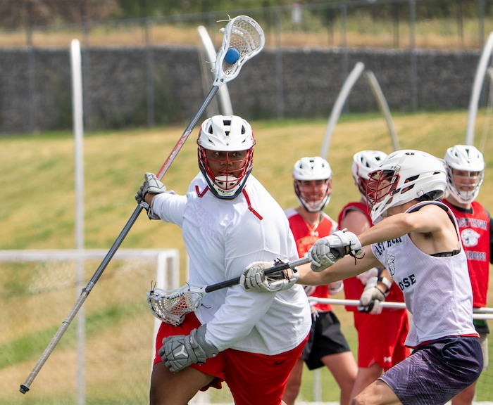 (Rick Egan | The Salt Lake Tribune)  Tui Tonga tries to get past his defender, in East youth lacrosse practice, on Wednesday, June 22, 2022.