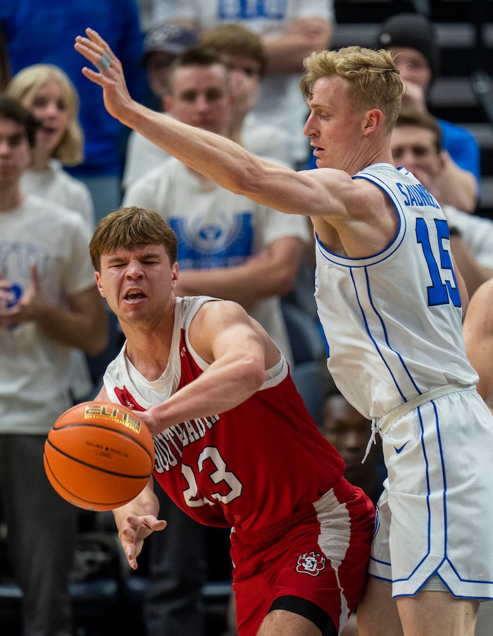 (Rick Egan | The Salt Lake Tribune)  South Dakota Coyotes guard Paul Bruns (23) is guarded by Brigham Young Cougars guard Richie Saunders (15), in basketball action between the Brigham Young Cougars and the South Dakota Coyotes, at Vivint Arena, in Salt Lake City, on Saturday, Dec. 3, 2022.