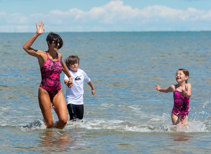 (Rick Egan  |  The Salt Lake Tribune)      Julia Story splashes through the water with her kids, Kyson, 9 and Thalia, 6, at the Great Salt Lake Saturday, June 8, 2019.  The cool temperatures resulted in a crowd of around 300 people, so the attempt to break the world record was turned into a polar plunge.