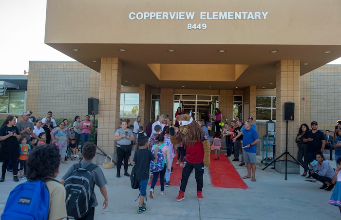 (Rick Egan | The Salt Lake Tribune)  Real Salt Lake mascot Leo the Lion gives high-fives to students as they walk the red carpet on the first day of school at Copperview Elementary School in Midvale, Monday, Aug. 19, 2019.