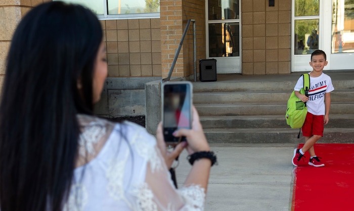(Rick Egan | The Salt Lake Tribune) Aja Borja takes photos of her son, Tatum, on his first day of school on the red carpet at Copperview Elementary School in Midvale, Monday, Aug. 19, 2019.
