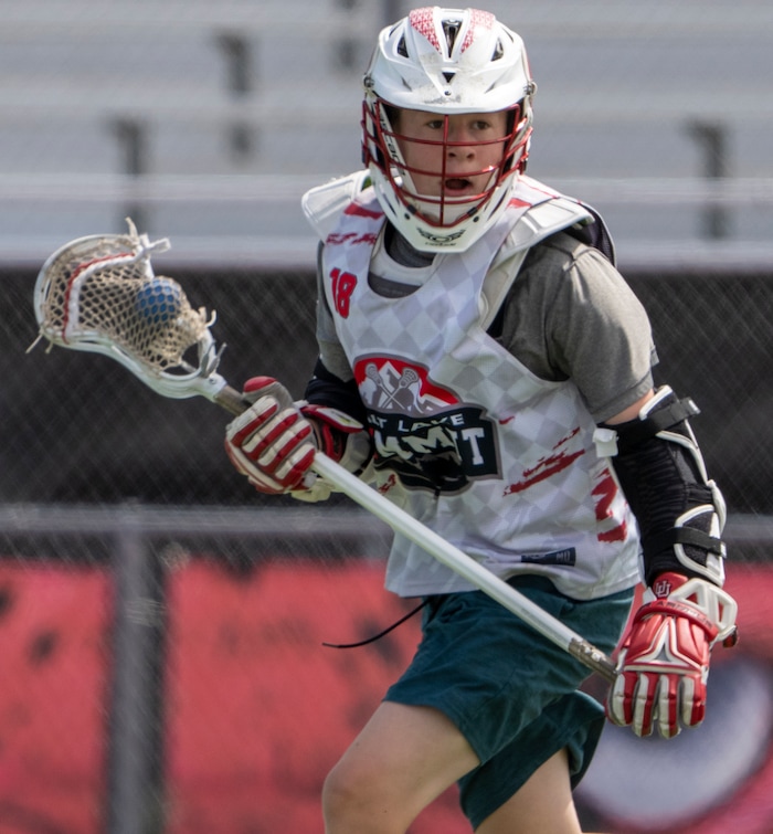 (Rick Egan | The Salt Lake Tribune)  Reilly Pearson-Ortolani runs with the ball, during East youth lacrosse practice, on Wednesday, June 22, 2022.