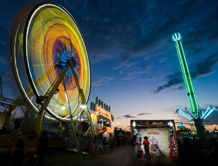 (Rick Egan  |  The Salt Lake Tribune)   The Ferris Wheel lights up the midway at the Utah State Fair, on a busy Monday,  Sept. 10, 2018.