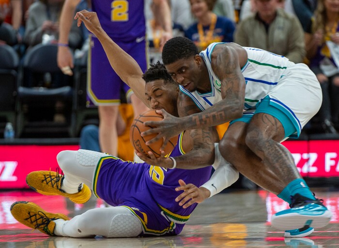 (Rick Egan  |  The Salt Lake Tribune)   Utah Jazz guard Donovan Mitchell (45) goes for a loose ball along with Charlotte Hornets guard Dwayne Bacon (7), in NBA action between the Utah Jazz and the Charlotte Hornets, in Salt Lake City,  Monday, April 1, 2019.