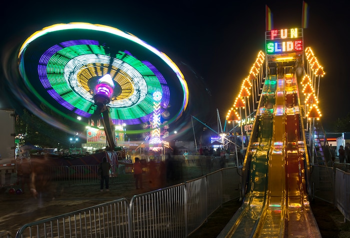 (Rick Egan  |  The Salt Lake Tribune)   The Cliff Hanger and the Fun Slide light up the midway at the Utah State Fair, on a busy Monday evening , Sept. 10, 2018.